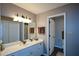Bathroom featuring double sinks with granite counters and a view of a tiled shower at 11050 Linbrook Ln, Duluth, GA 30097