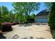 A look at the driveway and two car garage, set amongst mature trees and landscaping at 11050 Linbrook Ln, Duluth, GA 30097