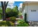 Landscaped garden with a single chair outside of the home's garage at 11050 Linbrook Ln, Duluth, GA 30097