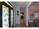 Elegant foyer with hardwood floors, decorative door, and views to the living room and kitchen at 11050 Linbrook Ln, Duluth, GA 30097