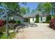 Well-maintained home with mature landscaping, stone accents, and an attached two-car garage at 11050 Linbrook Ln, Duluth, GA 30097