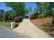 Home with large driveway bordered by meticulously maintained shrubbery at 11050 Linbrook Ln, Duluth, GA 30097