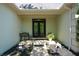 Inviting covered front porch area with slate tile, decorative plants and bench seating at 11050 Linbrook Ln, Duluth, GA 30097