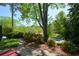 A view of the landscaped front yard, with lush plants and trees at 11050 Linbrook Ln, Duluth, GA 30097