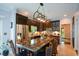Open kitchen with granite countertops, stainless steel appliances, and a central island at 11050 Linbrook Ln, Duluth, GA 30097