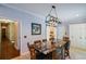 Kitchen island with granite countertop, seating, and nearby doors to other rooms at 11050 Linbrook Ln, Duluth, GA 30097