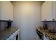 Functional laundry area with washer, dryer, granite counters, and ample cabinet space at 11050 Linbrook Ln, Duluth, GA 30097