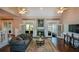 Bright and airy living room featuring vaulted ceilings, fireplace, and french doors to the outside at 11050 Linbrook Ln, Duluth, GA 30097