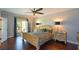 Elegant main bedroom featuring hardwood floors, French doors to a patio, and bedside tables at 11050 Linbrook Ln, Duluth, GA 30097