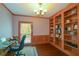 Well-lit office with hardwood floors, built-in bookshelves, and a work area by the window at 11050 Linbrook Ln, Duluth, GA 30097