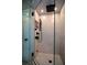 A large, tiled, walk-in shower, complete with glass door and overhead shower head and handheld wand at 11050 Linbrook Ln, Duluth, GA 30097