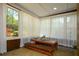 Bright sunroom with a dining area, stone floors, and a wall of windows for natural light at 11050 Linbrook Ln, Duluth, GA 30097