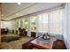 Bright sunroom with stone floors, large windows, and a cozy dining area with bench seating at 11050 Linbrook Ln, Duluth, GA 30097