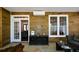 Sunroom with wood paneling, stone floors, outdoor access, and built-in storage at 11050 Linbrook Ln, Duluth, GA 30097