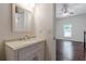 Chic bathroom with stylish vanity, mirror, and easy access to the adjacent bedroom for convenience at 1404 E Forrest Ave, Atlanta, GA 30344