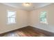 This bedroom offers hardwood floors, neutral paint, and bright windows for natural light at 1404 E Forrest Ave, Atlanta, GA 30344