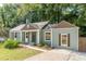 Charming blue home with a well-maintained lawn and inviting entryway, featuring complementary brown trim at 1404 E Forrest Ave, Atlanta, GA 30344