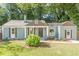 Charming craftsman-style home with a manicured lawn, quaint shutters, and inviting front entrance at 1404 E Forrest Ave, Atlanta, GA 30344