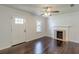 Bright living room with dark hardwood floors, a fireplace, and an adjacent front door at 1404 E Forrest Ave, Atlanta, GA 30344
