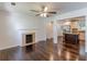 Open-concept living room features dark hardwood floors, fireplace, and seamless transition to the modern kitchen at 1404 E Forrest Ave, Atlanta, GA 30344