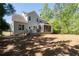 Exterior of home features a screened-in porch, wooden deck, and a spacious backyard at 1438 Sutters Pond Nw Dr, Kennesaw, GA 30152