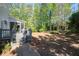 Backyard with screened-in porch, wooden deck, mature trees, and a grassy area at 1438 Sutters Pond Nw Dr, Kennesaw, GA 30152