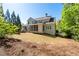 Beautifully landscaped backyard with a spacious lawn, deck, and mature trees, providing a private oasis at 1438 Sutters Pond Nw Dr, Kennesaw, GA 30152