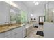 Updated main bathroom with a soaking tub, dual sinks, and a luxurious walk-in shower at 1438 Sutters Pond Nw Dr, Kennesaw, GA 30152