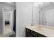 Bright bathroom features a large mirror, dark vanity, and tile flooring at 1438 Sutters Pond Nw Dr, Kennesaw, GA 30152