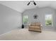 Spacious bedroom with vaulted ceilings, dual windows providing natural light, and cozy sitting area at 1438 Sutters Pond Nw Dr, Kennesaw, GA 30152