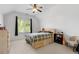 Cozy bedroom with vaulted ceilings, a ceiling fan, and natural light from a large window at 1438 Sutters Pond Nw Dr, Kennesaw, GA 30152