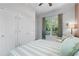 Bright bedroom with dual closets, a comfy chair by the window, and soft natural light at 1438 Sutters Pond Nw Dr, Kennesaw, GA 30152