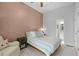 Inviting bedroom with a queen-sized bed, accent wall, chair, and access to a private bathroom at 1438 Sutters Pond Nw Dr, Kennesaw, GA 30152