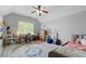 Bright bedroom with large windows, desk and seating area, and a cozy sleeping space at 1438 Sutters Pond Nw Dr, Kennesaw, GA 30152