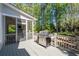 Back deck with gas grill, wood railings, and views of wooded backyard at 1438 Sutters Pond Nw Dr, Kennesaw, GA 30152