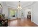Elegant dining area with hardwood floors, a chandelier, and large windows at 1438 Sutters Pond Nw Dr, Kennesaw, GA 30152