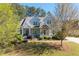 Charming two-story home with mature trees and a well-manicured front lawn at 1438 Sutters Pond Nw Dr, Kennesaw, GA 30152
