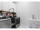 Well-organized laundry room features modern washer and dryer, sink, and built-in storage for efficient chores at 1438 Sutters Pond Nw Dr, Kennesaw, GA 30152