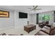Comfortable living room with large TV, leather furniture, and a big window for ample natural light at 1438 Sutters Pond Nw Dr, Kennesaw, GA 30152