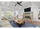 Cozy living room features a stone fireplace, backyard access, and is open to the eat-in kitchen at 1438 Sutters Pond Nw Dr, Kennesaw, GA 30152