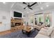 Inviting living room features a stone fireplace, coffered ceilings, and neutral furnishings with access to outdoor space at 1438 Sutters Pond Nw Dr, Kennesaw, GA 30152