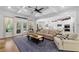 Spacious living room open to kitchen boasts ample seating, natural light, and backyard access at 1438 Sutters Pond Nw Dr, Kennesaw, GA 30152