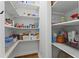Spacious pantry with wooden floors and ample shelving for organized storage at 1438 Sutters Pond Nw Dr, Kennesaw, GA 30152