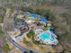 Aerial view showcasing the community amenities including pools, tennis courts, and lush landscaping at 317 Vista Lake Dr, Suwanee, GA 30024