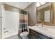 Bathroom featuring a shower-tub combination with curtain and vanity with a large framed mirror at 317 Vista Lake Dr, Suwanee, GA 30024