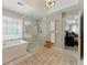 Bright bathroom with a free-standing tub, glass shower, and decorative rug at 317 Vista Lake Dr, Suwanee, GA 30024
