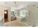 Bathroom showcasing a glass-enclosed shower, a soaking tub, and double vanities with neutral tones at 317 Vista Lake Dr, Suwanee, GA 30024