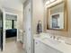 Bathroom with a bright marble countertop vanity and decorative mirror at 317 Vista Lake Dr, Suwanee, GA 30024
