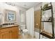 Bathroom featuring a vanity, mirror, toilet and a shower-tub combination with white shower curtain at 317 Vista Lake Dr, Suwanee, GA 30024