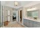 Bathroom featuring a vanity with drawers and cabinets, a large mirror, and a pendant light at 317 Vista Lake Dr, Suwanee, GA 30024